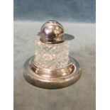 A silver mounted cylindrical hobnail-cut glass inkwell with jockeys cap hinged cover, on a