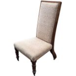 A Victorian mahogany nursing chair with rectangular upholstered back above a tapering seat, raised