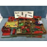 A quantity of Meccano including wheels, cogs, clockwork mechanisms, chains, instruction booklets,