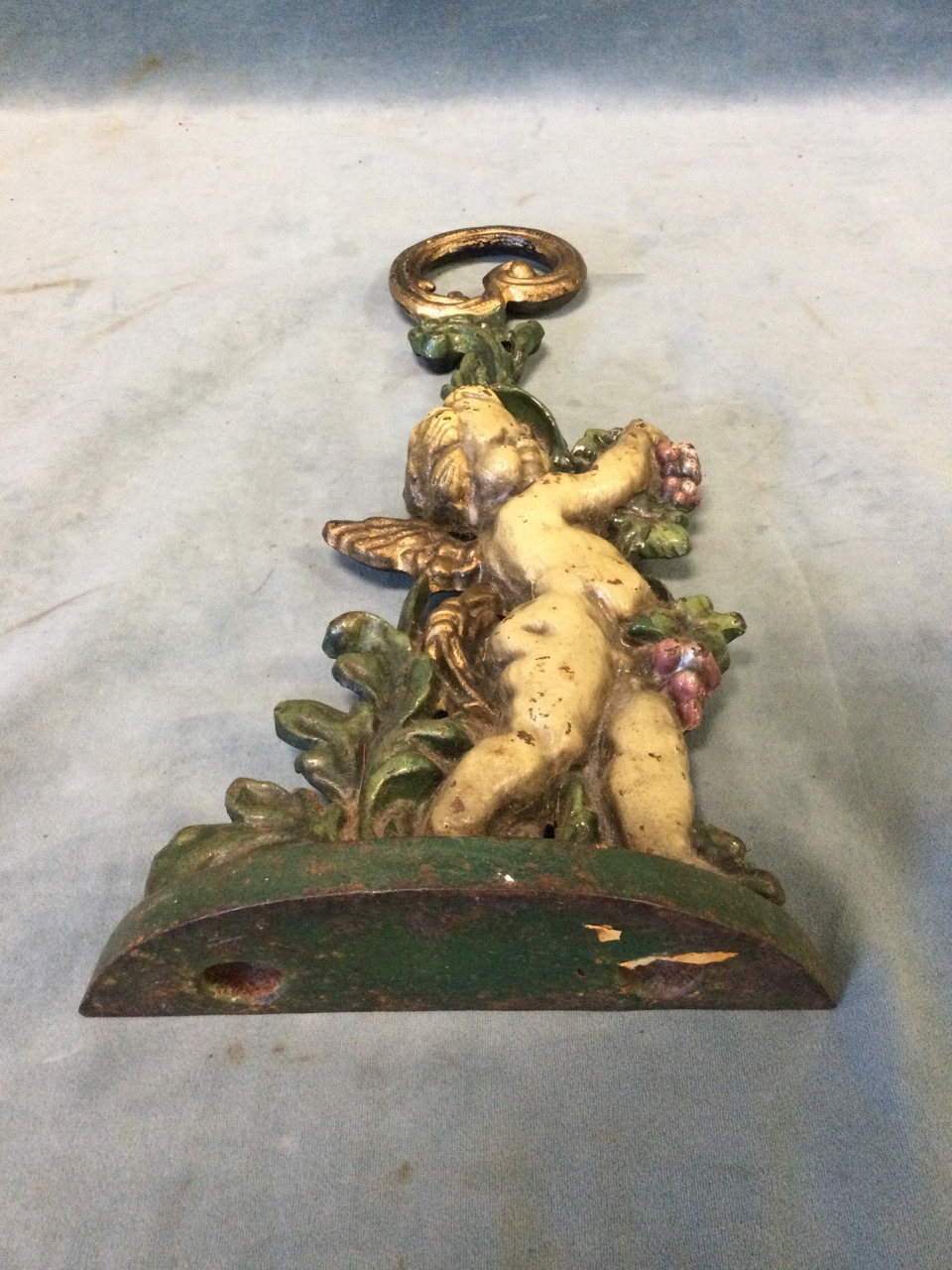 A Victorian cast iron doorstop modelled as a cherub with vines on crescent shaped base, with - Image 3 of 3