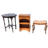 An ebonised scalloped top occasional table raised on turned legs with castors, joined by