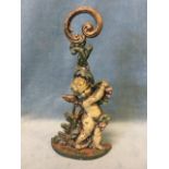 A Victorian cast iron doorstop modelled as a cherub with vines on crescent shaped base, with