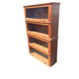 A mahogany globe vernicke style glazed bookcase in four sections, with up-and-over knobbed glass