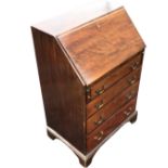 A small mahogany bureau, the moulded fallfront enclosing an interior with cupboard, drawers and