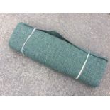 A bolt of Harris tweed fabric, with a subtle check in tones of green, blue and grey. (29.5in wide)