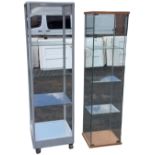 A square display cabinet on casters, with rounded metal frame supporting glass shelves - 19.5in x