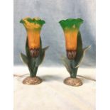 A pair of art nouveau style tablelamps, the glass shades in the form of ayrum lilies, on metal