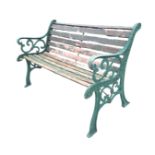 A rectangular 4ft garden bench, the slatted back and seat with scrolled ends and arms, raised on