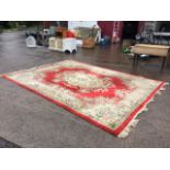 A Chinese Aubusson pattern carved wool carpet, the scarlet ground with central floral medallion, the