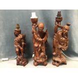 Three Chinese carved hardwood figures of buddhist immortals with bone inlay, mounted as