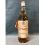 A 1967 bottle of Dewars Scotch whisky, the unopened 70% proof 26 2/3 fl oz bottle with racehorse