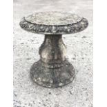 A circular composition stone garden table with egg & dart moulded rim on leaf cast column above a