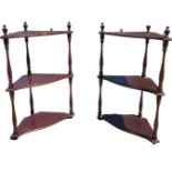 A pair of mahogany hanging corner shelves with serpentine shaped platforms on baluster turned