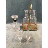 A Victorian oak and silver plated stand with two cut glass decanters; a cut glass spirit decanter