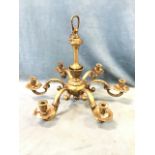 A heavy Edwardian gilt bronze chandelier with six scrolled branches supporting urn shaped leaf