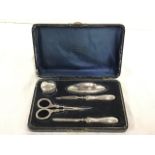 A cased hallmarked silver manicure set with scissors, file, buffer, etc. - Samuel M Levi,