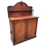 A Victorian mahogany chiffonier, the arched back with scrolled carving above a shelf on turned