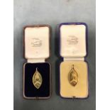 Two cased 9ct gold elliptical school medals dated 1934/5, surmounted by rings - 16g. (1.5in) (2)