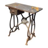 An industrial cast iron stand with rectangular wood top above a small drawer with cup handle, the
