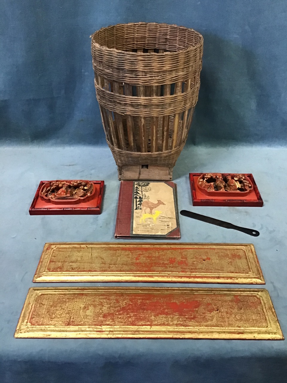 An antique Japanese split bamboo basket - 17in; a pair of Burmese red and gold lacquer panels - 21.