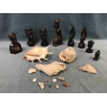 A collection of seven African carved ebony busts, some showing traditional scarification patterns; a