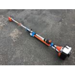 An unused and extending petrol powered pole pruner saw, with hedge trimmer attachment.
