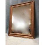 A rectangular wall mirror in a reeded and moulded stained pine frame. (22.25in x 28in)