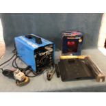 A Clarke arc welder - model 180 turbo; a boxed new auto dimming welding helmet; miscellaneous