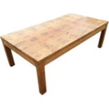A rectangular pine coffee table, the top with marquetry blocks above a plain frieze, raised on