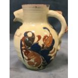 A Victorian Brannam pottery slipware beer jug, with fish form handle and spout, the body with floral