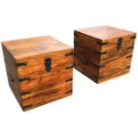 A pair of hardwood cube box stools with brass military style mounts, having swing carriage handles