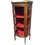 A nineteenth century mahogany D-shaped ormolu mounted Louis V style vitrine, the rouge marble top