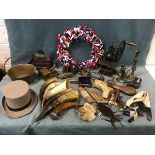 Miscellaneous western campfire gear including a coffee grinder, a brass pan, a copper powder horn,