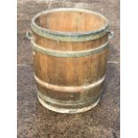 A coopered oak log barrel with iron hoops and carrying handles. (21in x 22in)
