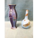 A Carlton bottle shaped vase decorated with gilded butterflies on pale blue mottled lustre