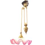 A late Victorian rise & fall brass light with waved cranberry rimed shade on pulley cables with