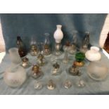A collection of glass oil lamps, some pairs, some chimneys & globes, moulded reservoirs, etc. (A