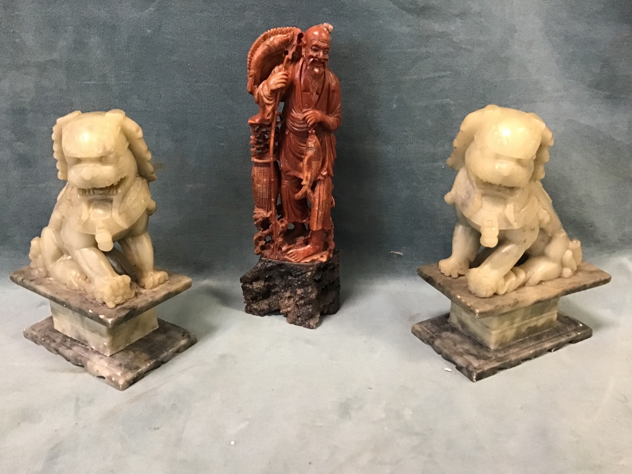 A pair of Chinese carved soapstone Fo dogs on plinths - 7.5in; and a carved soapstone figure of a