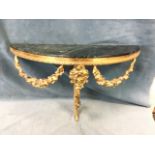A gilt brass and marble wall-mounted demi-lune console table, the verde antico top above a floral