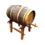 A coopered oak barrel, with a wood tap and cork bung, on a pegged oak stand with iron carrying