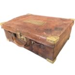 A leather cartridge case with brass mounts, having fitted interior with six straps. (19in)