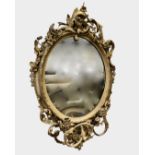 A mid-19th century giltwood and gesso girandole, the original oval mirror plate in an elaborate