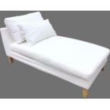 A contemporary 5ft upholstered chaise, the wide upholstered seat with loose cushions, raised on