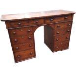 A nineteenth century mahogany kneehole desk with rectangular rounded top above a frieze with two