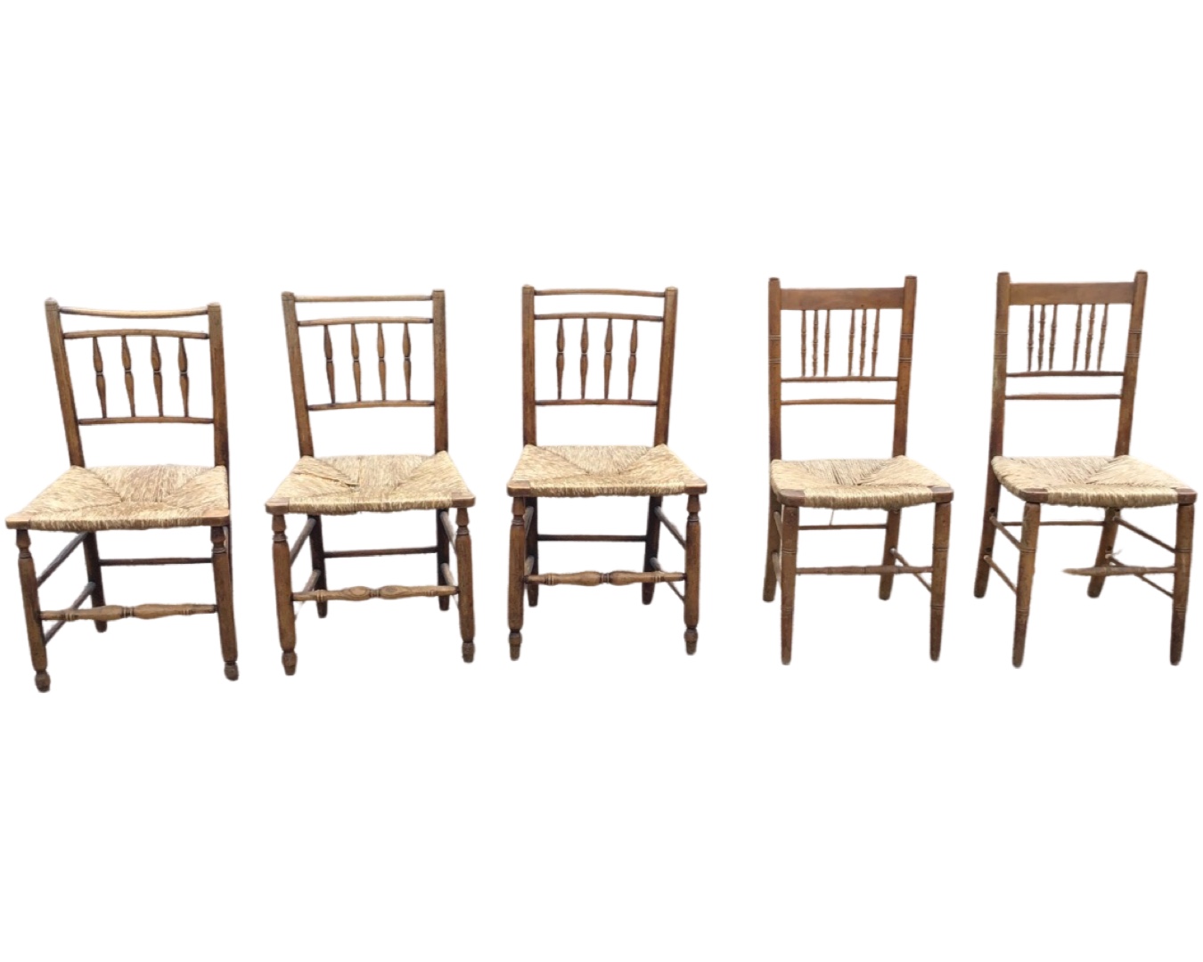 A married set of nineteenth century country oak rush seated chairs with turned spindles to backs,