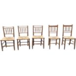 A married set of nineteenth century country oak rush seated chairs with turned spindles to backs,