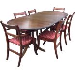 A Georgian style mahogany dining table and chair set, the crossbanded table with spare leaf and