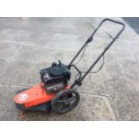 A DR rotary garden strimmer/mower with petrol Briggs & Stratton 190cc engine, the push-along machine