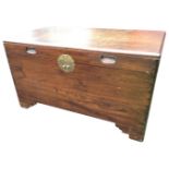 A C20th eastern camphorwood box with circular scalloped brass escutcheon and inset leaf carved