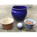 A bulbous blue glazed terracotta garden pot; a marble ball; and two flared stoneware bowls. (4)